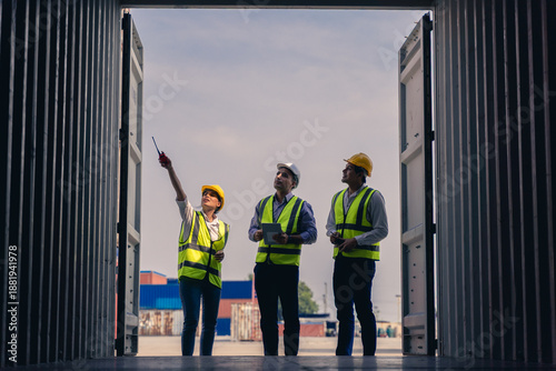 Team of workers discussing logistics operations at container yard