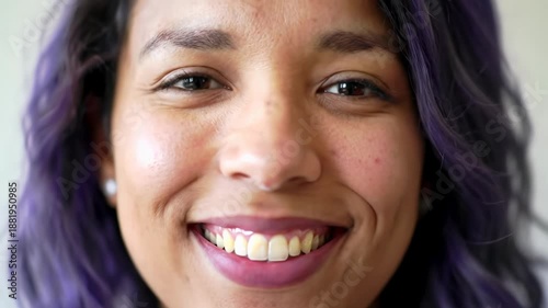 An ethnically diverse young adult's radiant smile, eyes sparkling with confidence on a creamy blurred background, soft lighting. Concept of profound self-assurance and vitality
