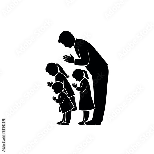 Father and children praying together in silhouette.