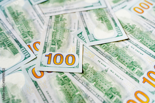 American bills of 100 US dollars are laid out on the surface and occupy the entire area of ​​the image, the background is made of American dollars, greenbacks of large denominations