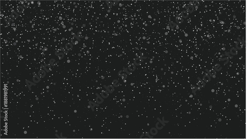 Snowflakes falling against dark background