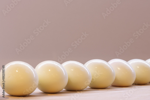 Tableau sur toile A diagonal row of hard-boiled eggs on a kitchen worktop