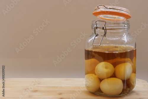 Fotografie Preserving jar full of pickled eggs on kitchen worktop