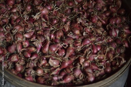 Traditional bamboo tray filled with harvested red shallots background
