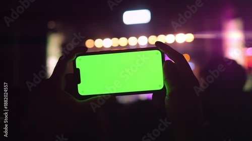 Man holding and swiping phone chroma key screen in the park walking on the street, smartphone close up in hands, Girl with green screen on smart phone. 