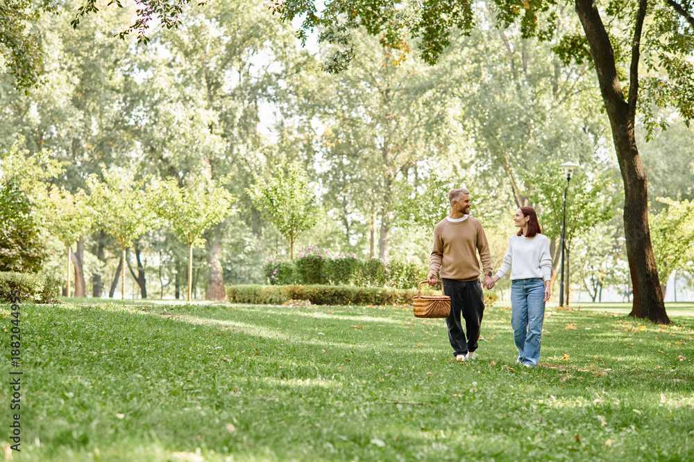 Fototapeta premium Couple enjoying a cheerful spring stroll through a vibrant green park