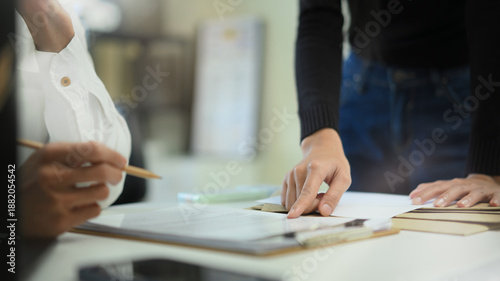Photos Two business people planing, consulting and meeting with paper work at office