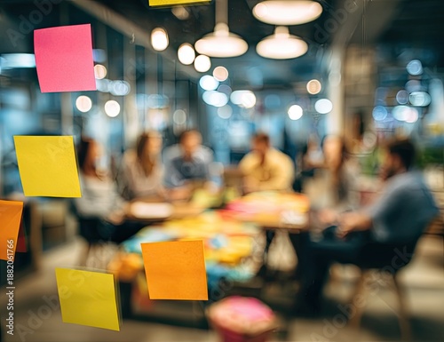 Blurred view of a team brainstorming with colorful sticky notes