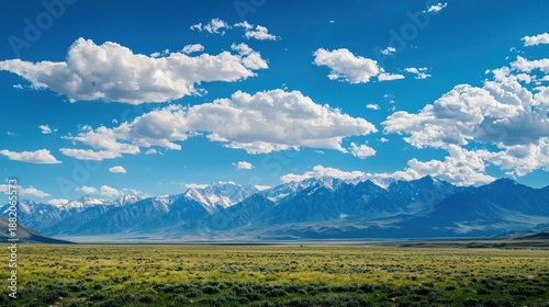 A panoramic mountain range stretching endlessly under a vast sky emphasizing the immensity of nature