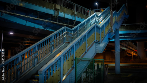 Bild auf Leinwand Urban Pedestrian Staircase at Night with Blue Steel Structure