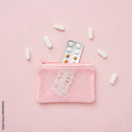 Wallpaper Mural Pink Mesh Cosmetic Pouch with Scattered Oral Contraceptive Pills and Blister Pack on Pastel Pink Background – Flat Lay Photography Torontodigital.ca