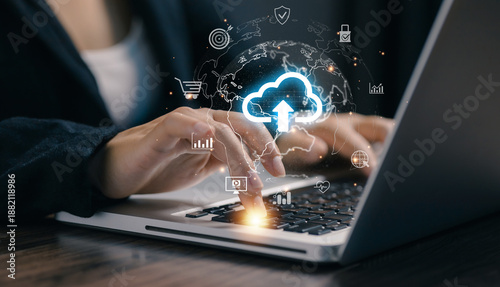 Business professional using laptop with cloud upload icon, representing cloud computing, data storage, cybersecurity, and digital transformation for modern online business and remote work solutions.