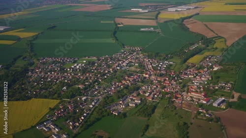 Aerial view of small village and farm fields.