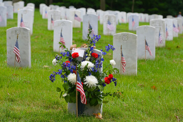 Headstones and National flags in Arlington National Cemetery - Circa Washington D.C. United States of America
