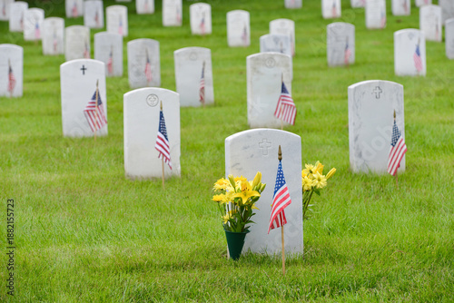 Headstones and National flags in Arlington National Cemetery - Circa Washington D.C. United States of America
