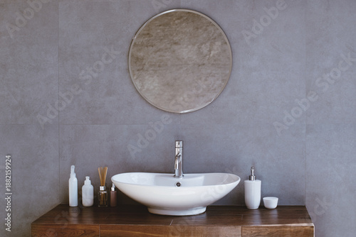 Fotografi The setting shows a bathroom with a wooden table and a white round sink