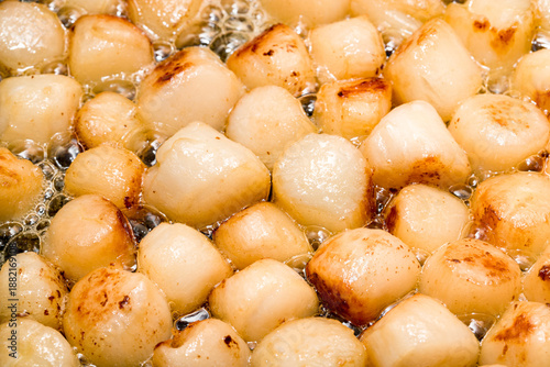 Scallop fried in olive oil close up