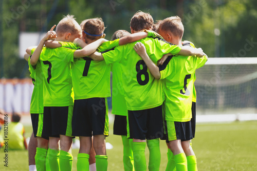Young football soccer players in sportswear. Young sports team united. Team tactic talk before the final match. Soccer school tournament