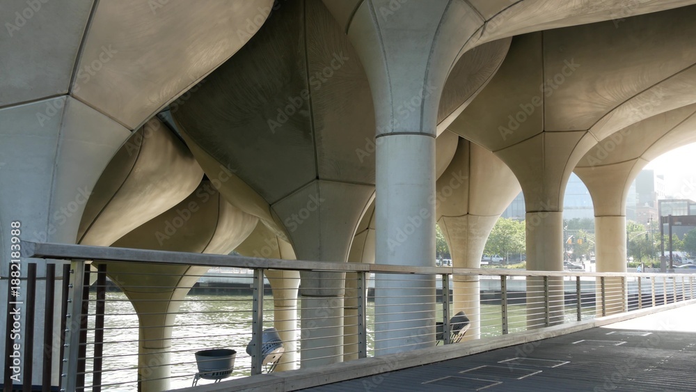 Obraz premium New York City Little Island pier park in Midtown of Manhattan, United States. Urban architecture on pillars in Chelsea, USA. Futuristic contemporary design, river water reflections on concrete columns