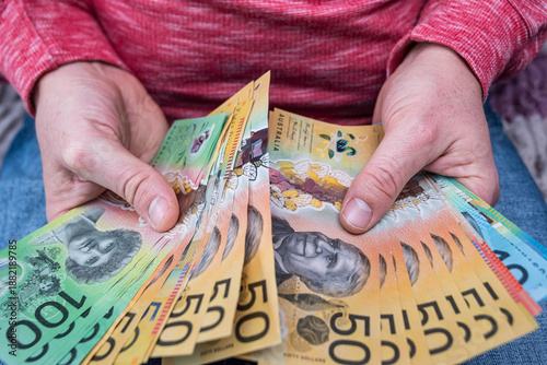 Person showing bunch of AUD currency bills, concept of travel budget and international trade
