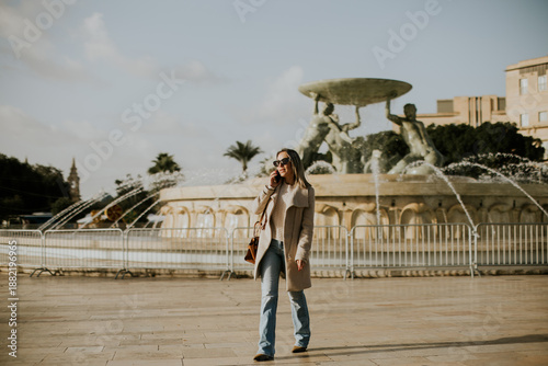 Woman walks near fountain w...