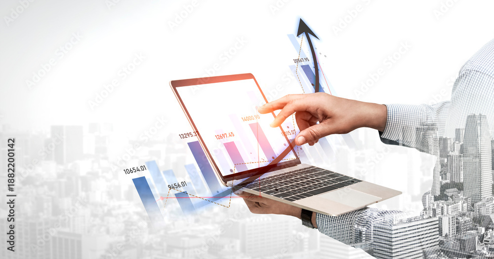 Obraz premium A business professional engages with financial data on a laptop, showcasing a growing trend in a digital format against an urban skyline background. Scalp