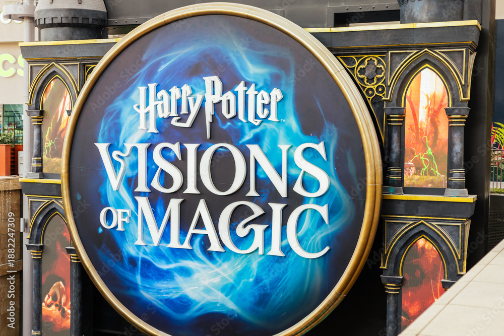 Naklejka premium Singapore - January 7, 2026: Visitors gather around an exhibition dedicated to fantasy themes. It features a display named Visions of Magic. The setting is in Singapore's busy area