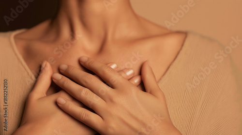 Woman placing hands on chest, finding peace feeling calm, expressing self love through mindful breathing