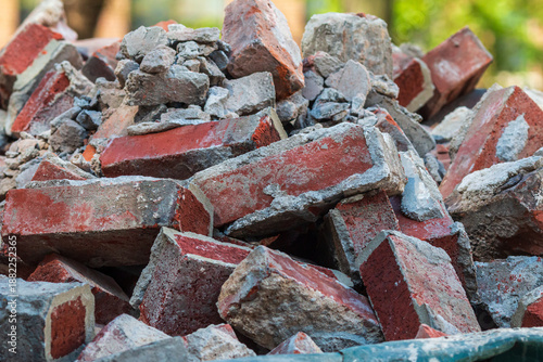 Discarded bricks are piled high in construction dumpster