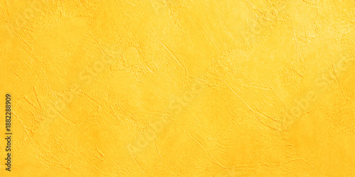 A vintage yellow stucco wall background with a rough grunge texture and aged parchment design featuring an antique stained orange pattern on a blank retro backdrop
