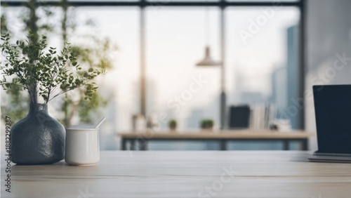 Modern office desk with vase and laptop