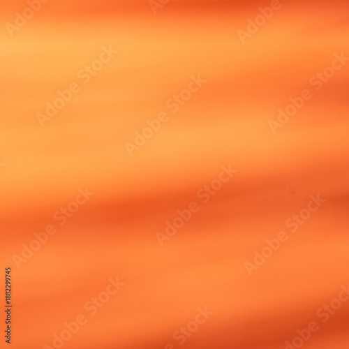 Abstract warm orange and yellow gradient background with soft light blur