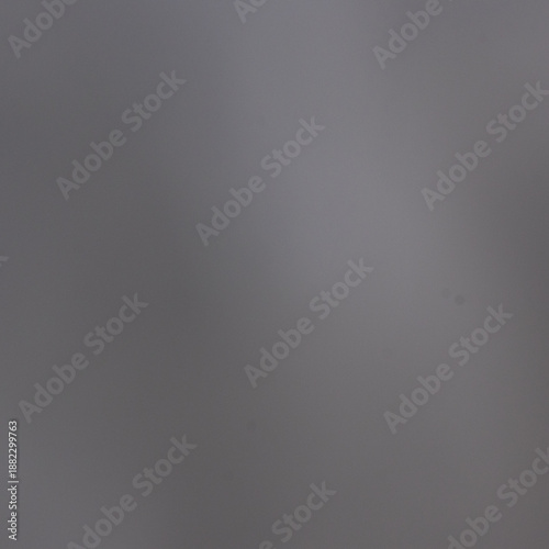 Minimalist smooth grey gradient background with subtle natural light and soft texture