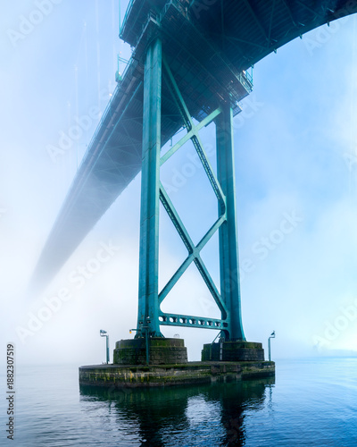 Lions Gate Bridge Tower Mist and Fog.The Lions Gate Bridge over the First Narrows of Burrard Inlet on a foggy day. 
