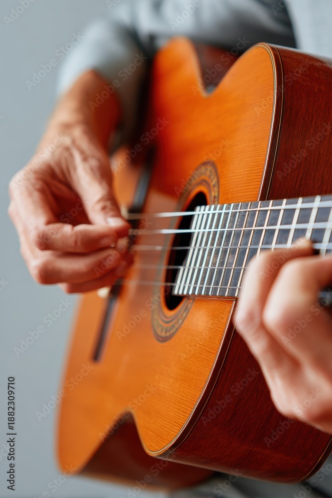 Fototapeta premium Close-up of hands playing an acoustic guitar