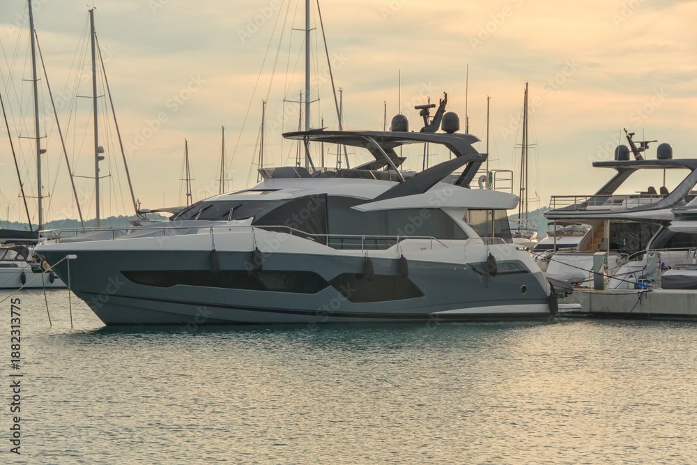 Fototapeta premium Modern luxury motor yacht with grey hull moored in marina