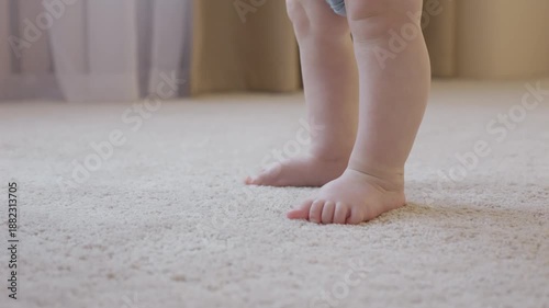 Wallpaper Mural Adorable small feet are practicing walking softly on plush carpet. Delightful tiny toes begin their gentle exploration of walking on soft rug surface. Neutral tones and authentic lighting Torontodigital.ca