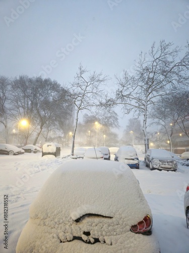 A snowy landscape in the Netherlands. Cars are covered with snow. Car outdoor in a winter morning with snow covered.