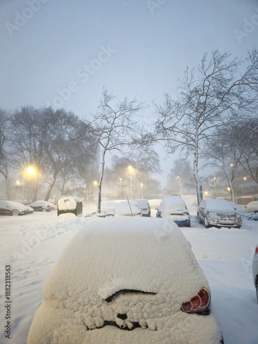 A snowy landscape in the Netherlands. Cars are covered with snow. Car outdoor in a winter morning with snow covered.