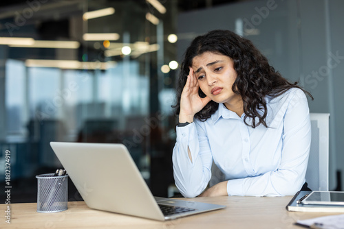 Принти на полотні Young woman feeling stressed and fatigued, experiencing a severe headache while