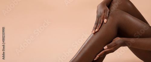 Bild auf Leinwand A woman is gently touching her smooth legs with her hands