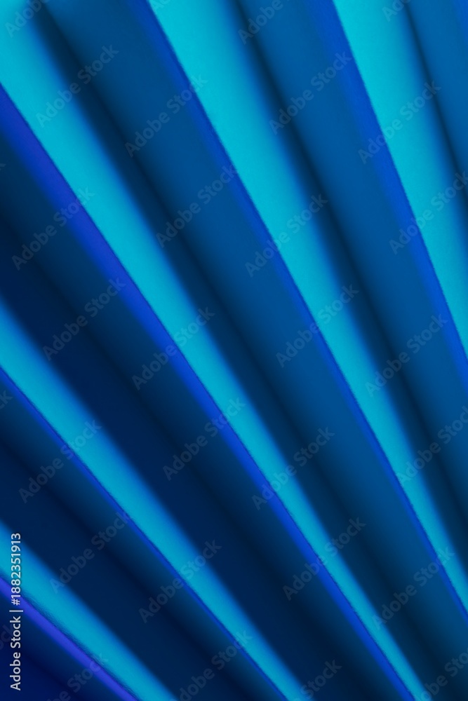 Fototapeta premium Abstraction of folded paper with dramatic shadows and bluish tones.