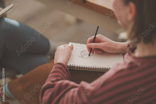Slika na platnu Lady sketching in a notebook Mindfulness Sketching By Hand Relaxed Lifestyle Ske