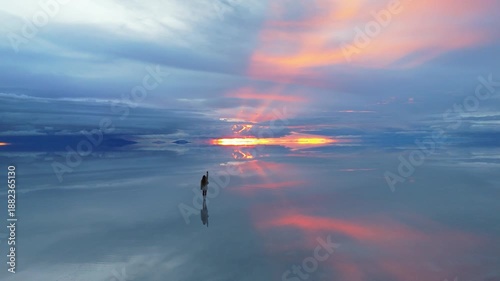 A breathtaking sunset over the expansive salt flats of Bolivia, capturing the serene beauty of nature's reflection