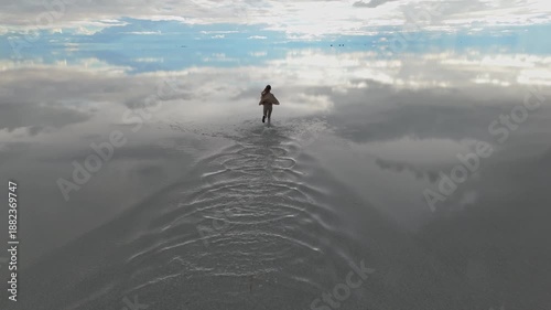 A solitary figure running across the expansive Salar de Uyuni in Bolivia, capturing the serene beauty of the world's largest salt flat