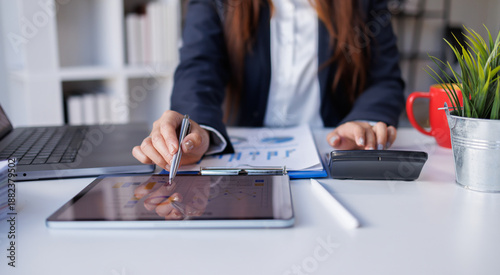 Bilde på lerret Closeup of business woman analyzing financial reports and calculating data at of