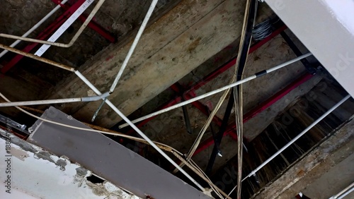 A network of pipes and cables installed in the ceiling in building construction