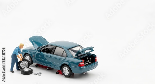 Cute Miniature Person Changing a Flat Tire on a Broken-Down Car, Insurance and Accident Concept with Copy Space