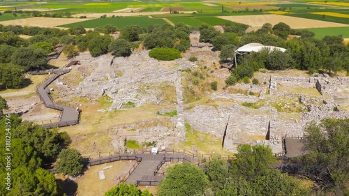 Tevfikiye, Turkey. Aerial view of the South Gate and paved stone road of Troy VI, flanked by vegetation and ancient stone stelae. Aerial view, Point of interest