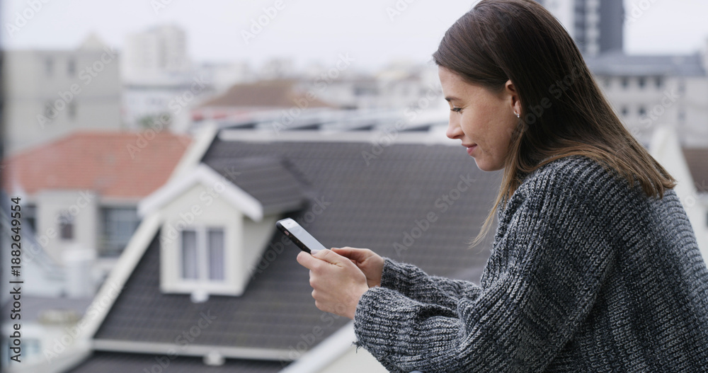 Fototapeta premium Home, woman and texting with phone on balcony for communication, mobile chat and notification. Smile, person and relax with smartphone at apartment for internet browsing, social media post and email
